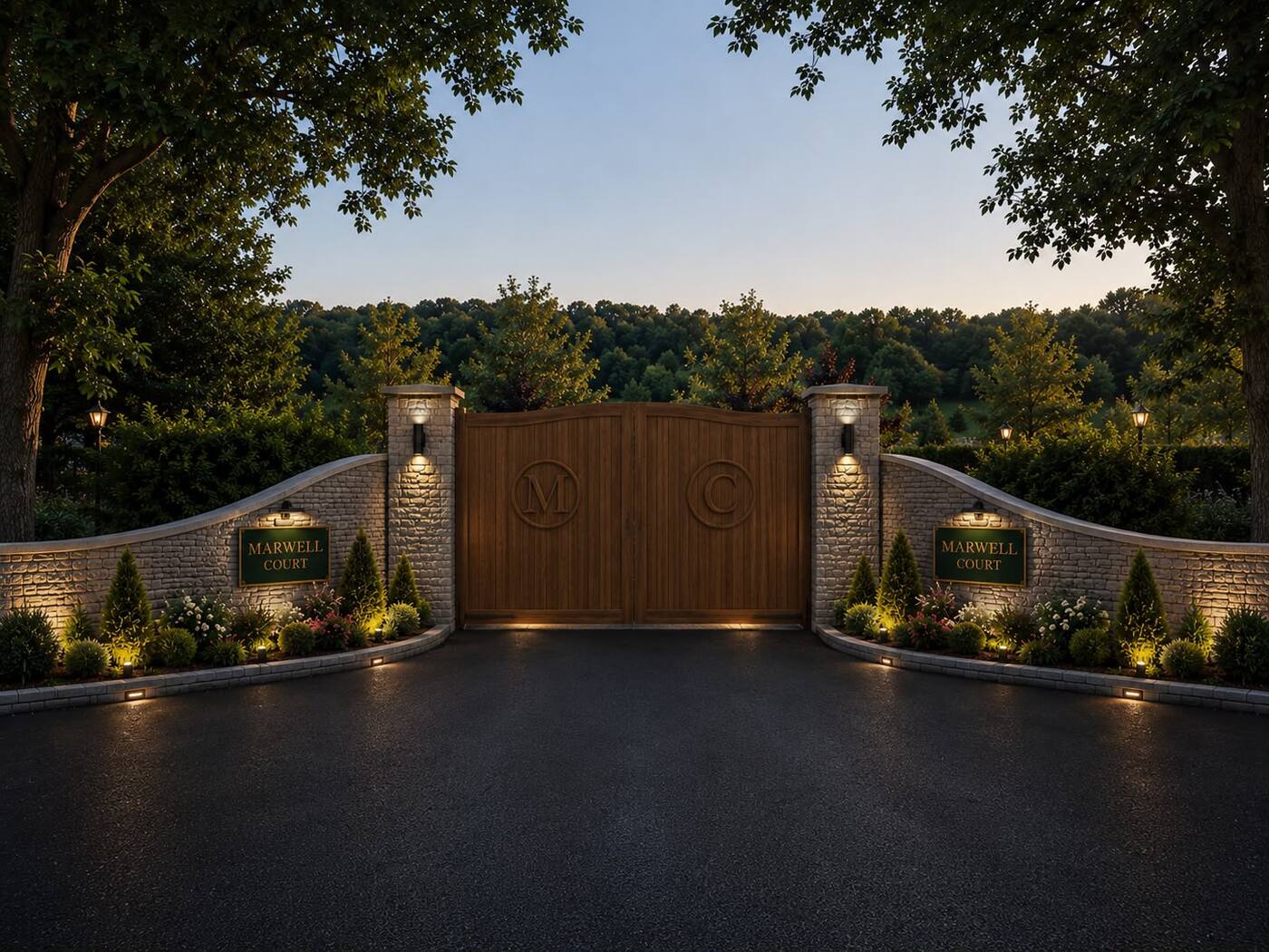 The gated stone entrance to Marwell Court at dusk, lit and planted, with woodland beyond.