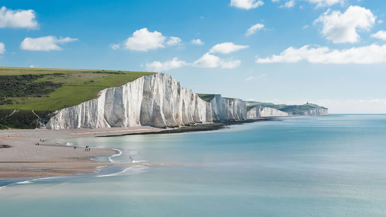 The Seven Sisters white chalk cliffs stretching along the Sussex coast.