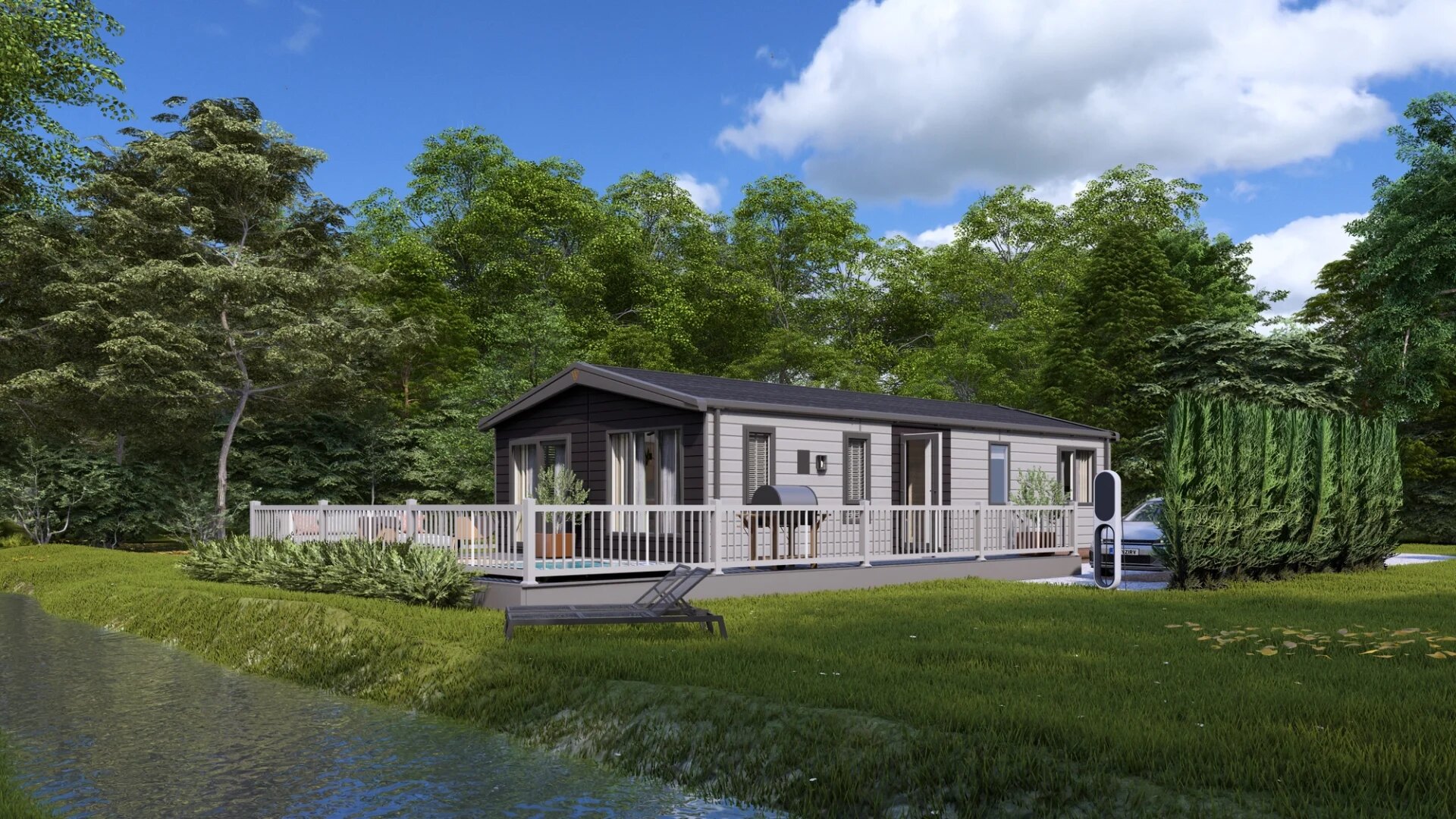 A larger family lodge with wraparound deck, glazed gable and lawns beyond.