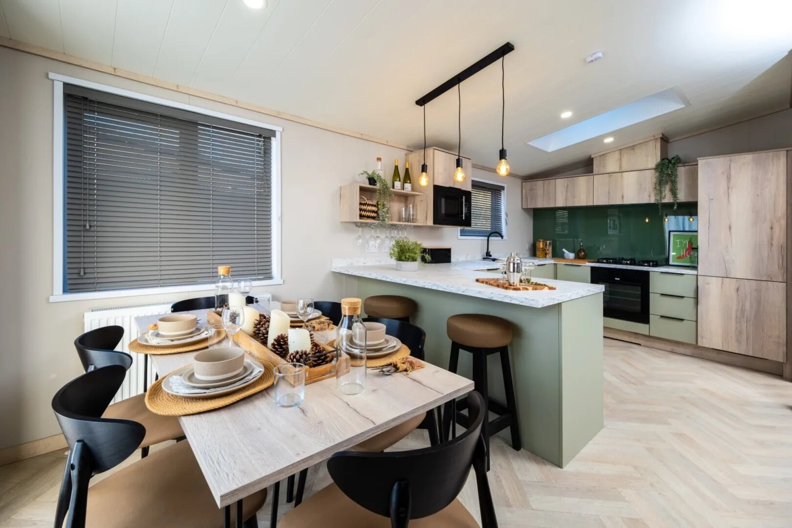 A lodge kitchen with marble-effect worktops, wood cabinetry and a breakfast bar.