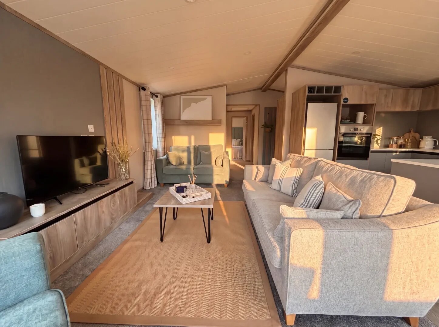 A lodge lounge with modular seating, wood panelling and full-height glazing.