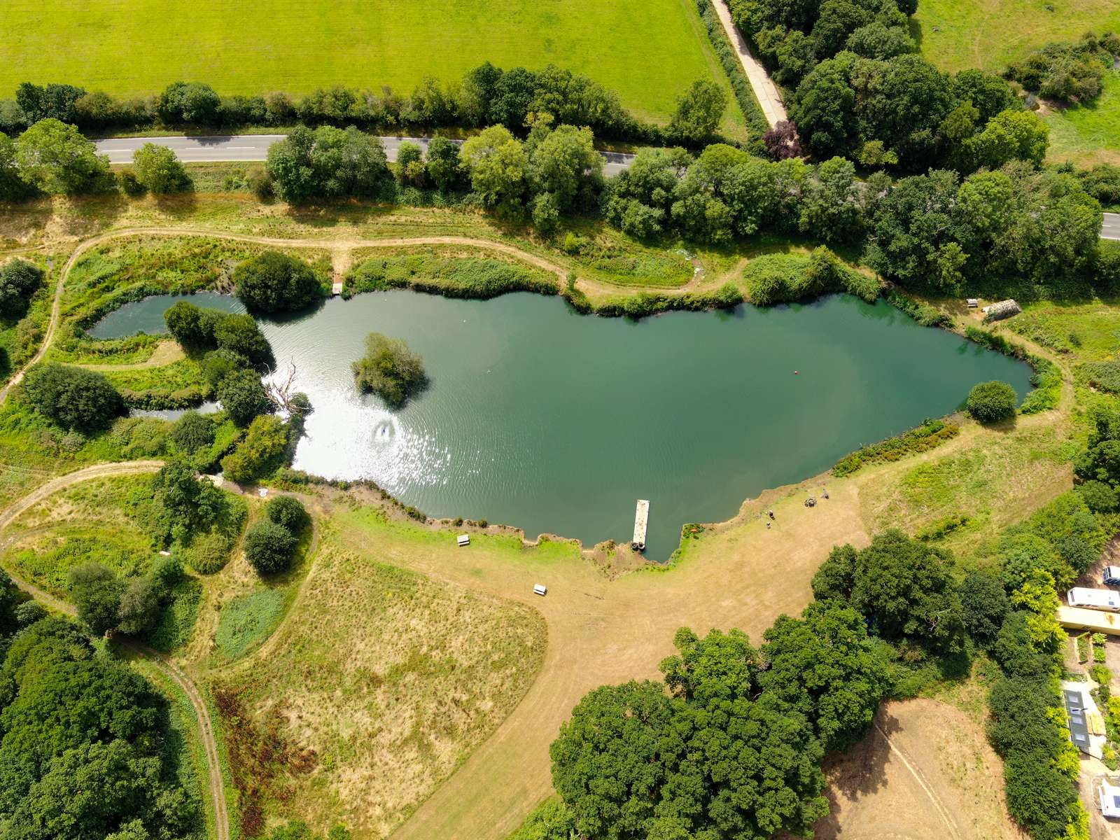 Aerial view over Marwell Resort showing lakes, lodge grounds and woodland.