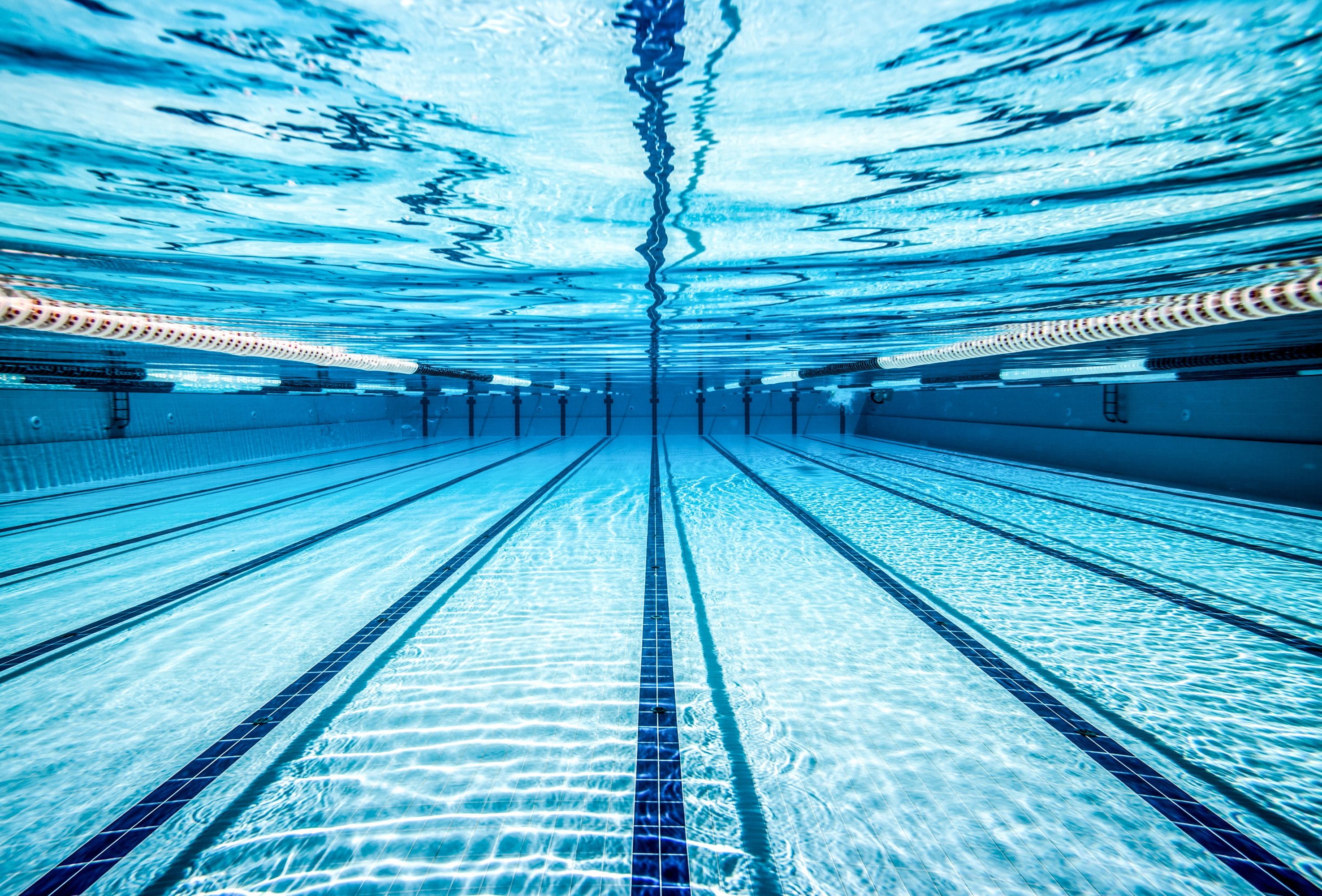 Underwater view along the lanes of a swimming pool.