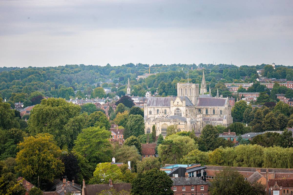 Winchester Cathedral rising above the rooftops and treetops of the historic city.